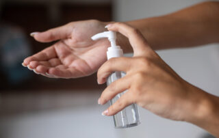 Photo of a person using hand sanitizer