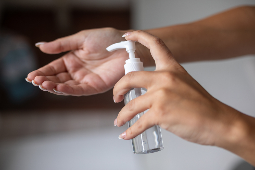 Photo of a person using hand sanitizer